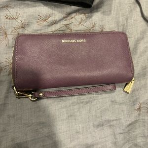 Michael Kors purple leather zipper wallet with wrist strap, gold hardware